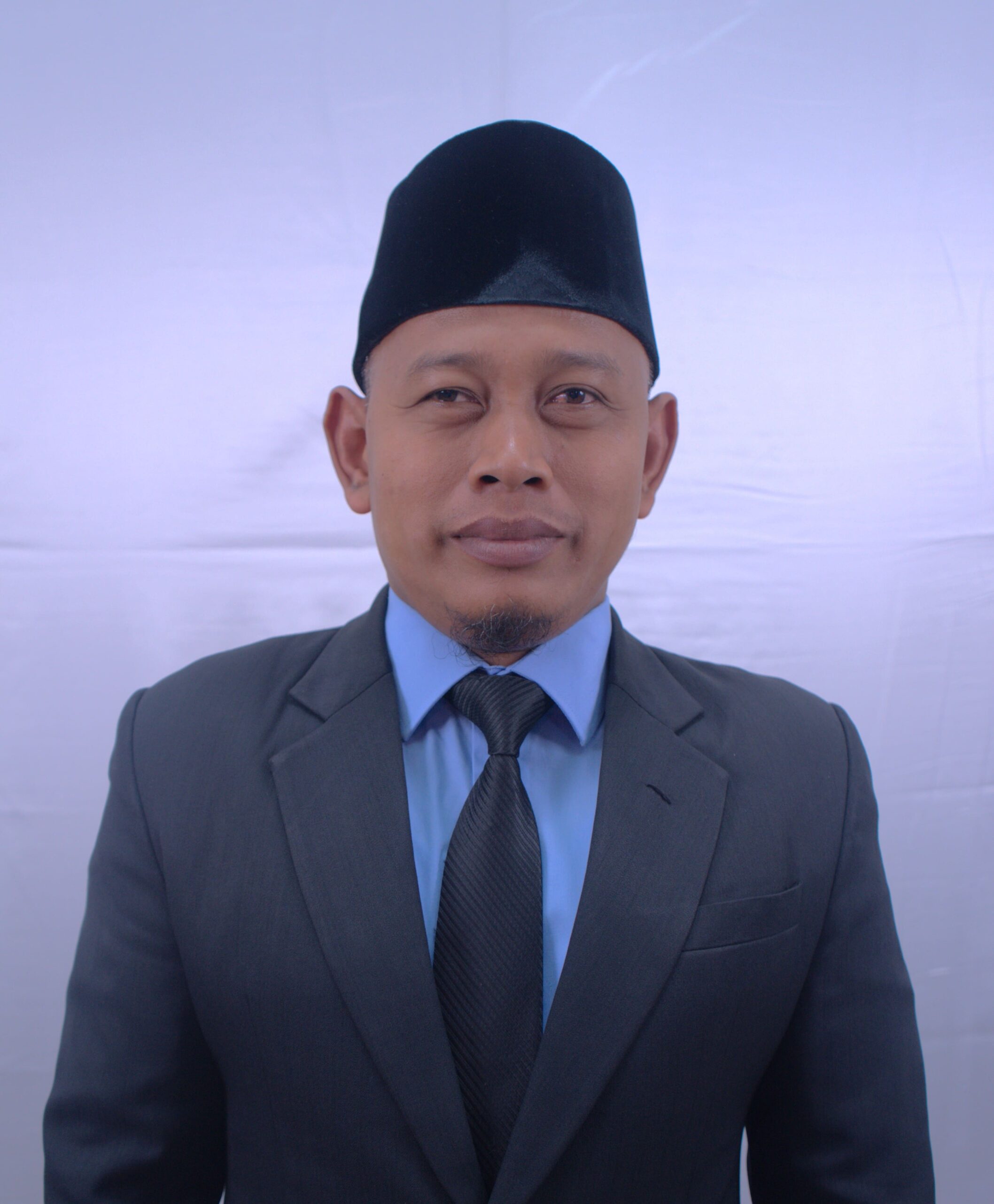 Portrait photograph of the head of infrastructure bureau wearing formal attire with professional lighting and neutral background